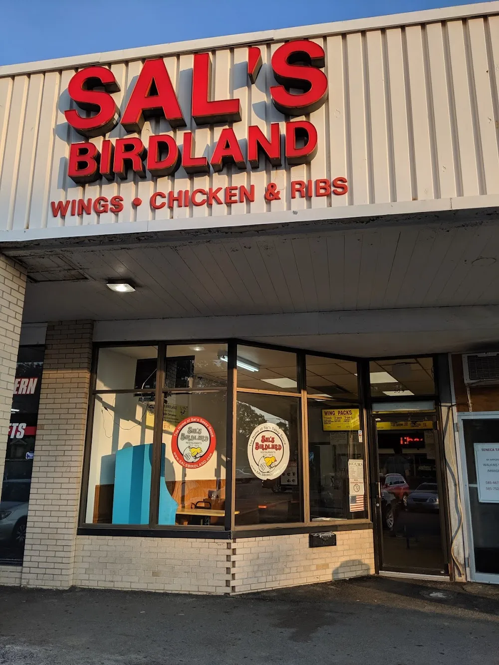 Sal's Birdland storefront and red sign on Ridge Road East in Rochester, New York